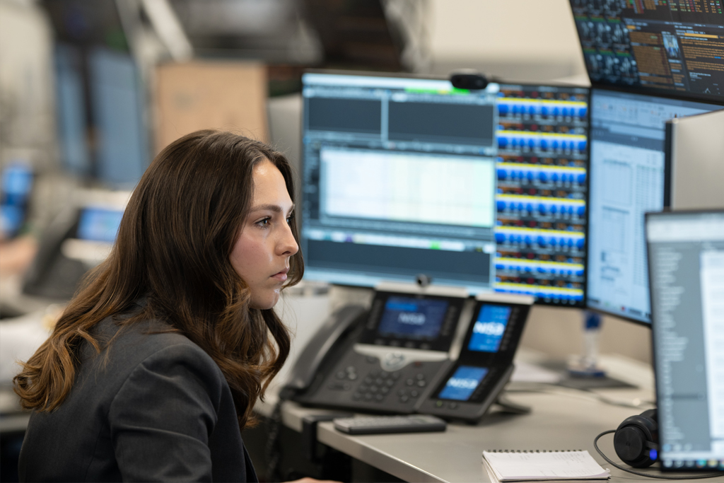 Analyst reviewing on computer screens